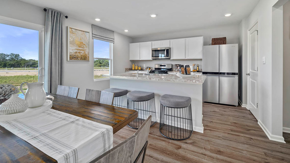 Dining and kitchen area with a glass sliding door.