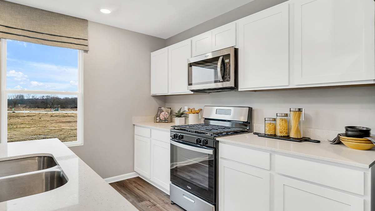 Kitchen with a side window and appliances.