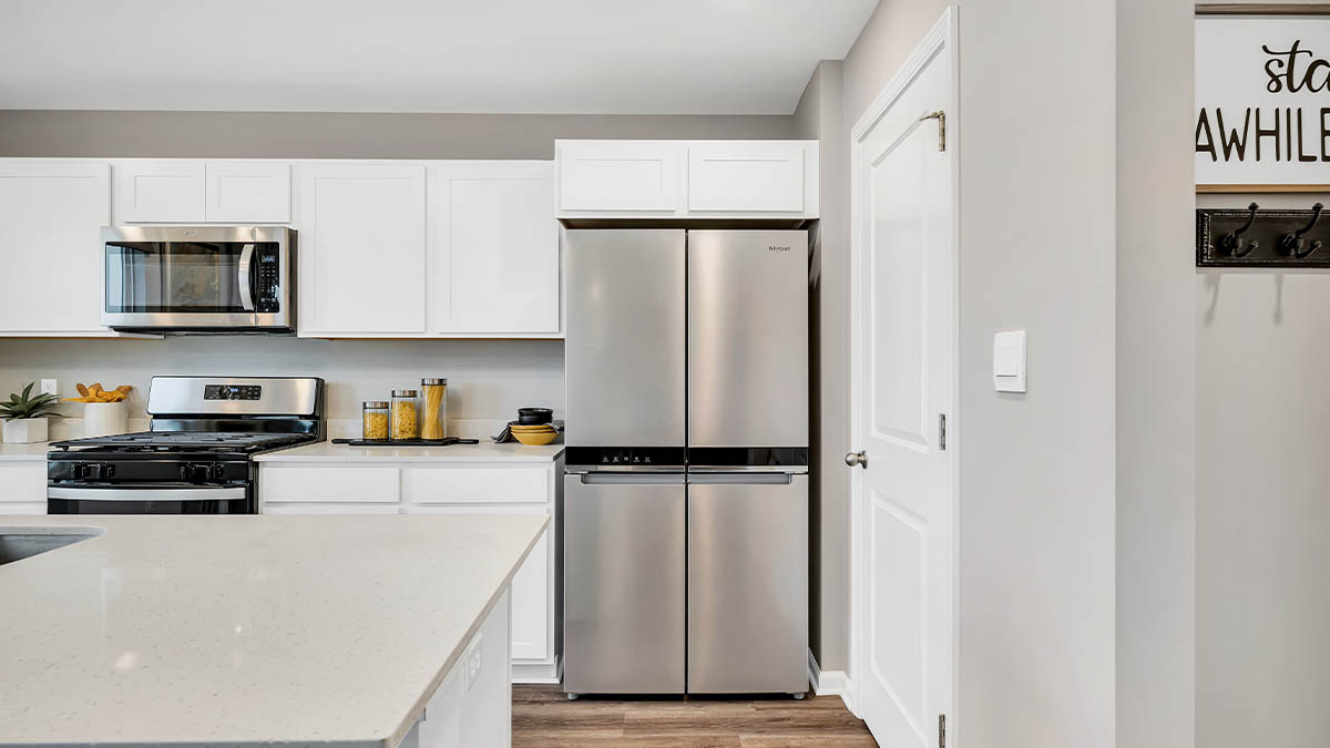 Kitchen with white cabinetry and appliances.