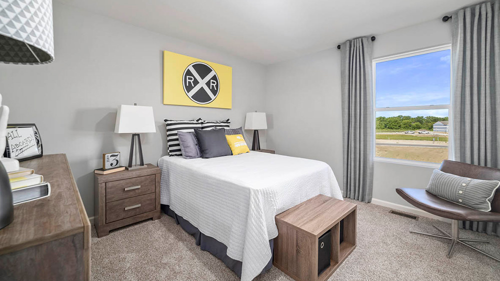 Bedroom with a window and carpeted floors.