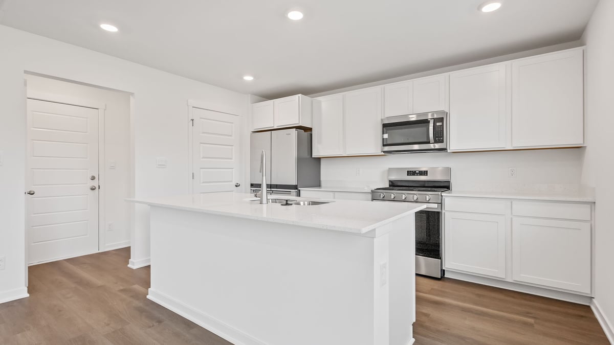Kitchen with quartz countertops and hard wood floors.