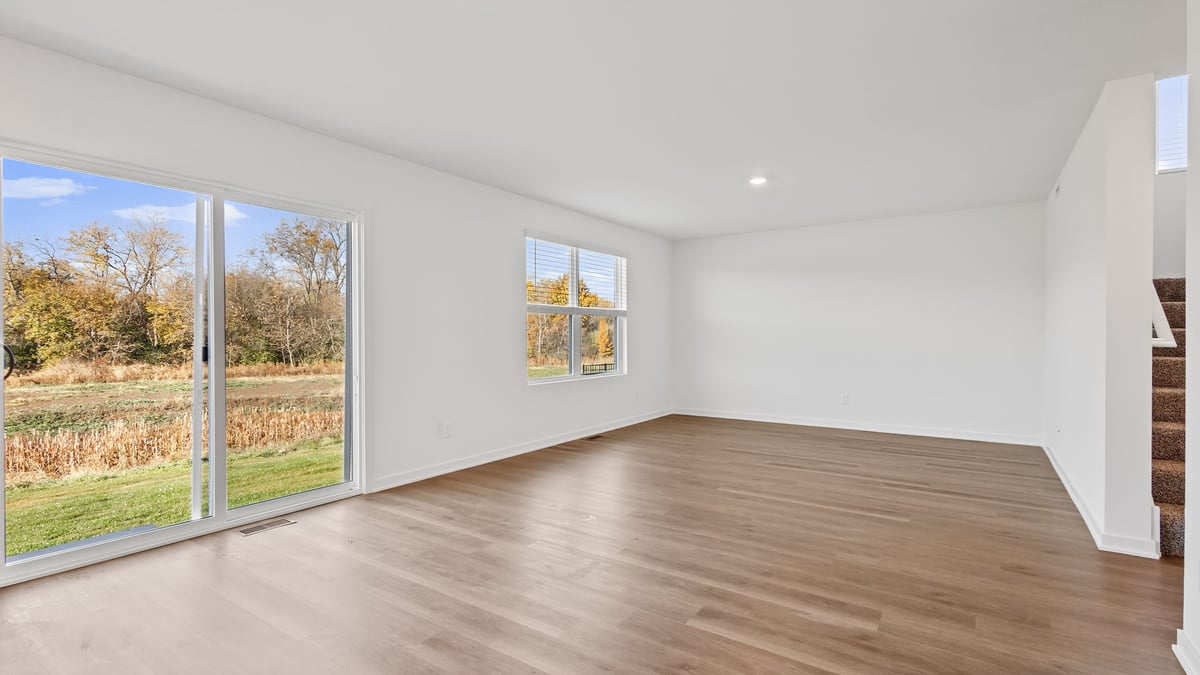 Dining area and living area with glass sliding doors and a big window.