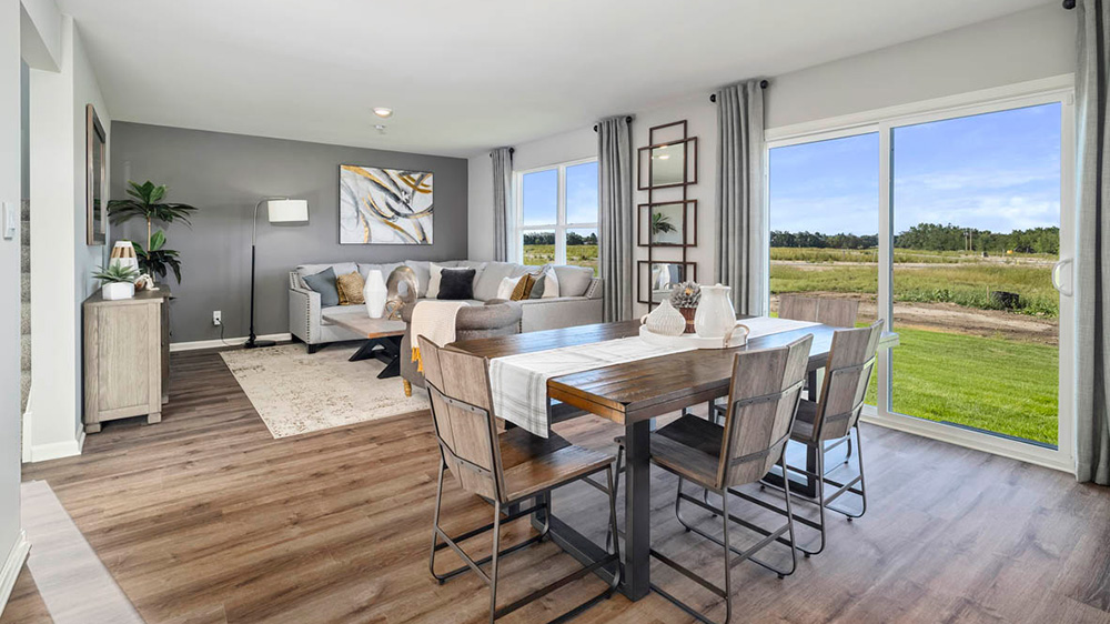 Dining area with glass sliding doors with view of living area.