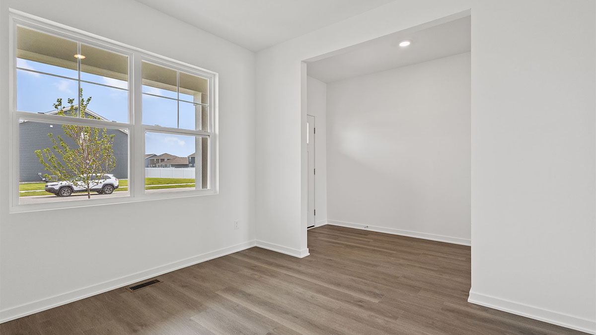 Front room with a big window and view of front door.