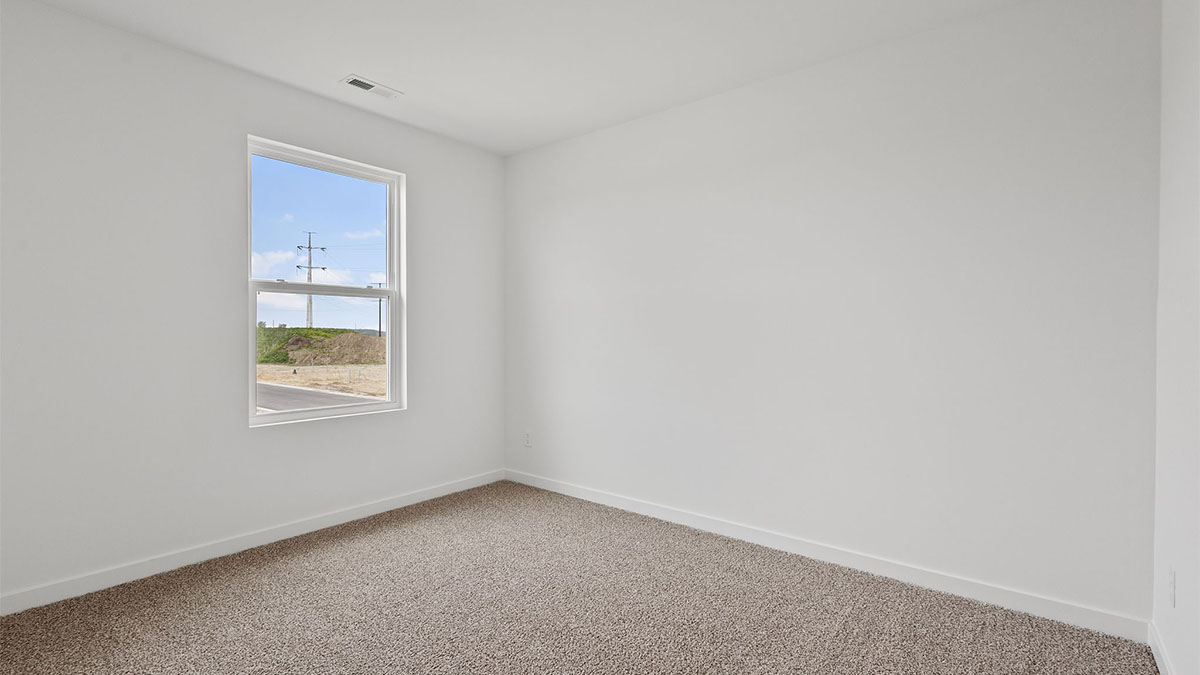 Bedroom with a window and carpet.