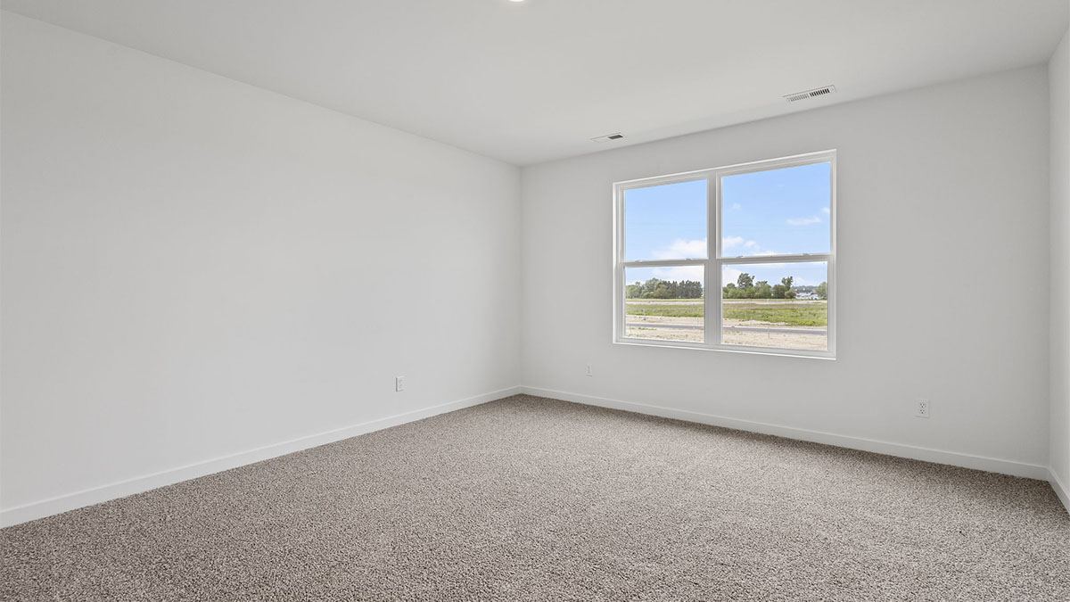 Bedroom with carpet and windows.