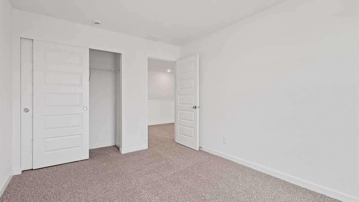 Bedroom with carpet with a closet.