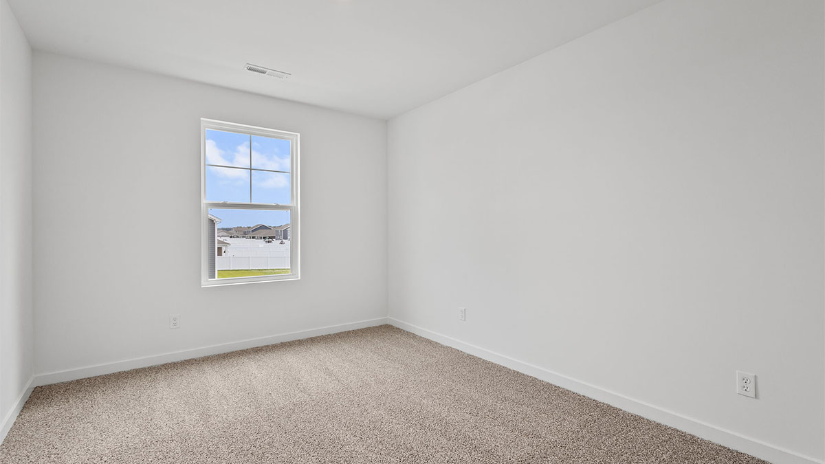 Bedroom with carpet and a window.