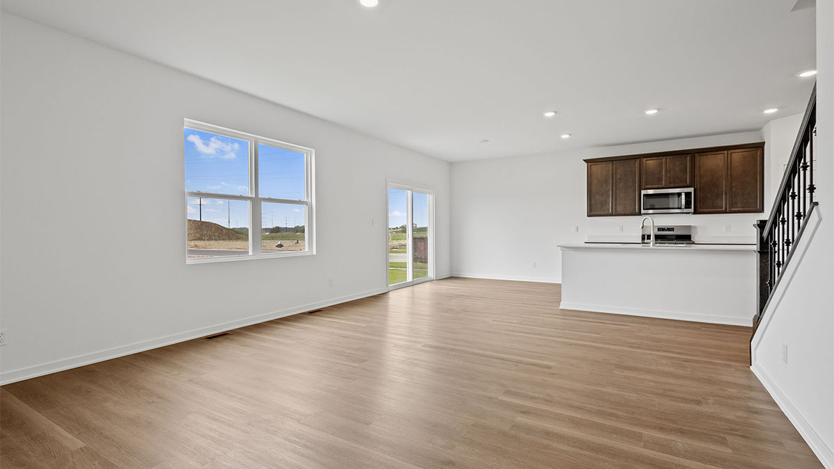 Living room with hard wood floors and windows.