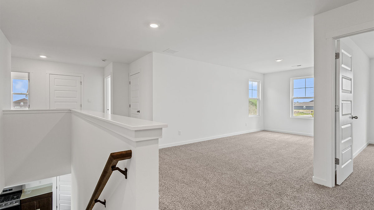 Top of staircase on second level viewing the loft room.