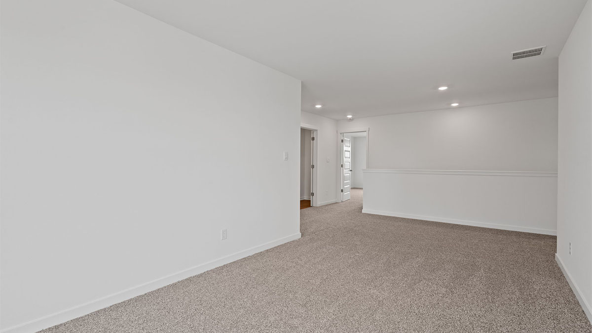 Loft room with carpet.