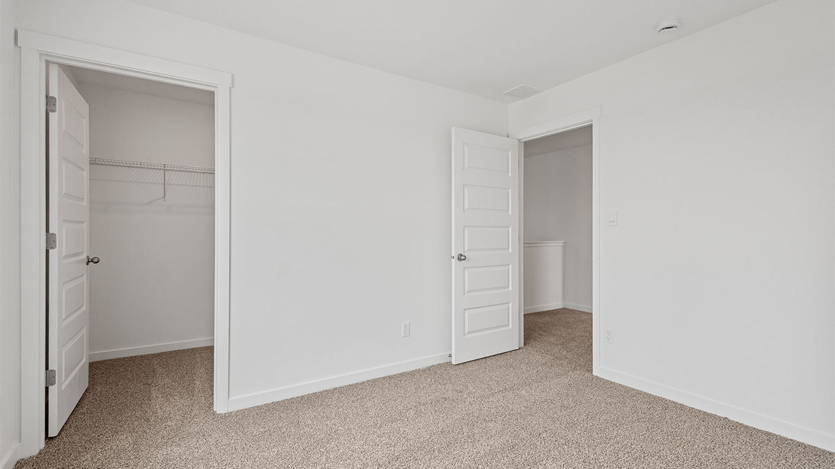 Bedroom with carpet and a closet.