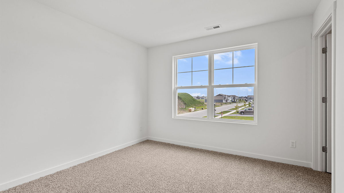 Bedroom with carpet and a window.