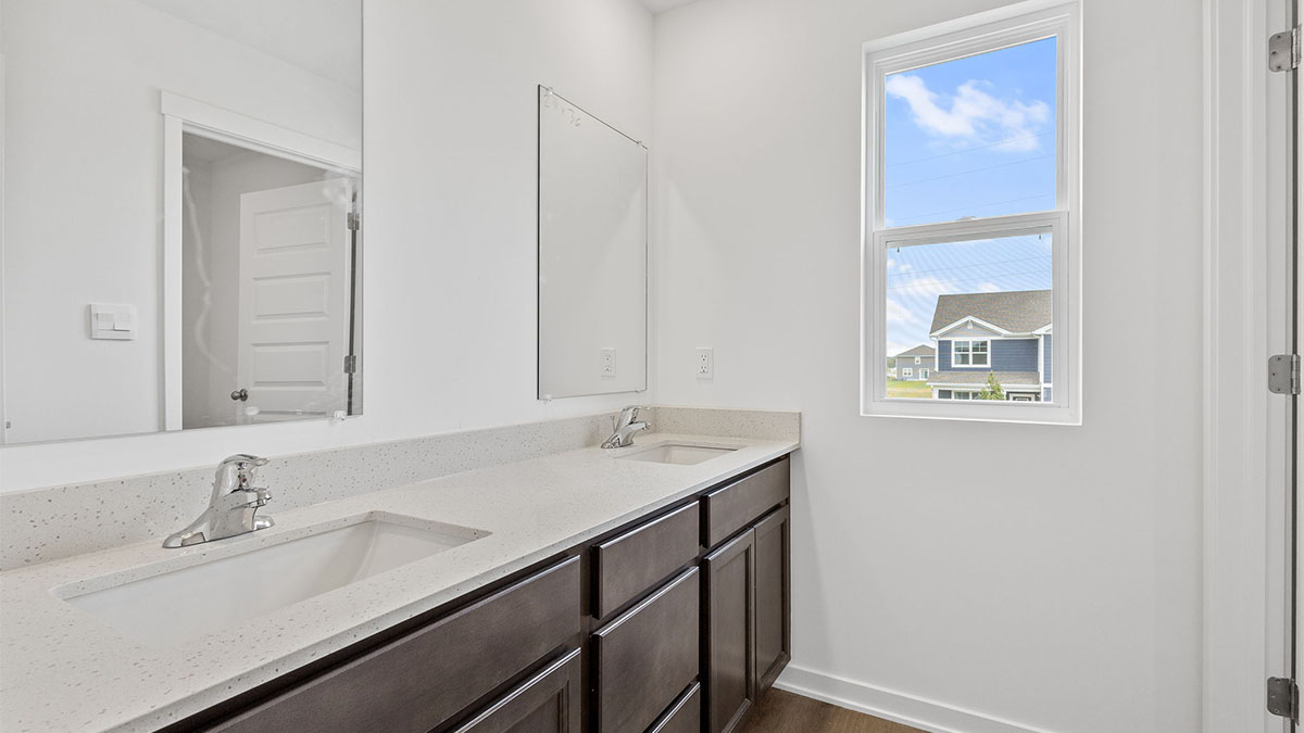 Dual vanity sinks with a shower.