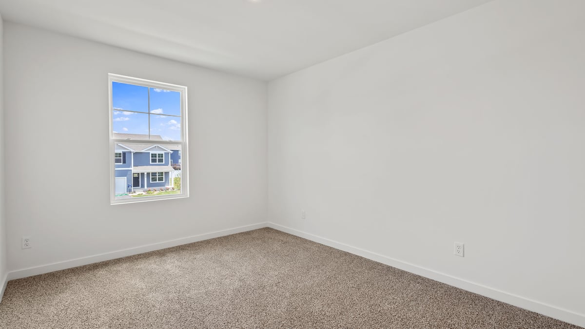 Bedroom with carpet and a window.