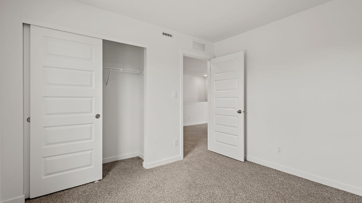 Bedroom with carpet and a closet.