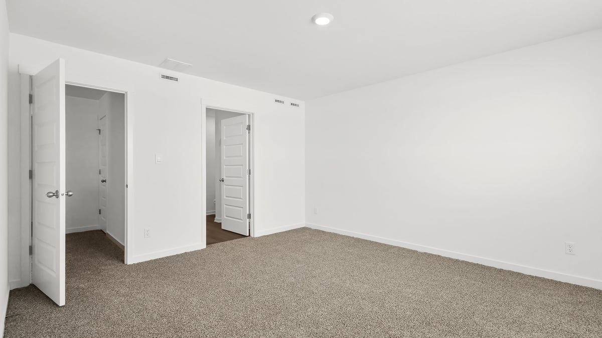 Bedroom with carpeted floors and a closet.