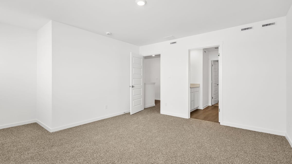 Primary bedroom with carpeted floors.