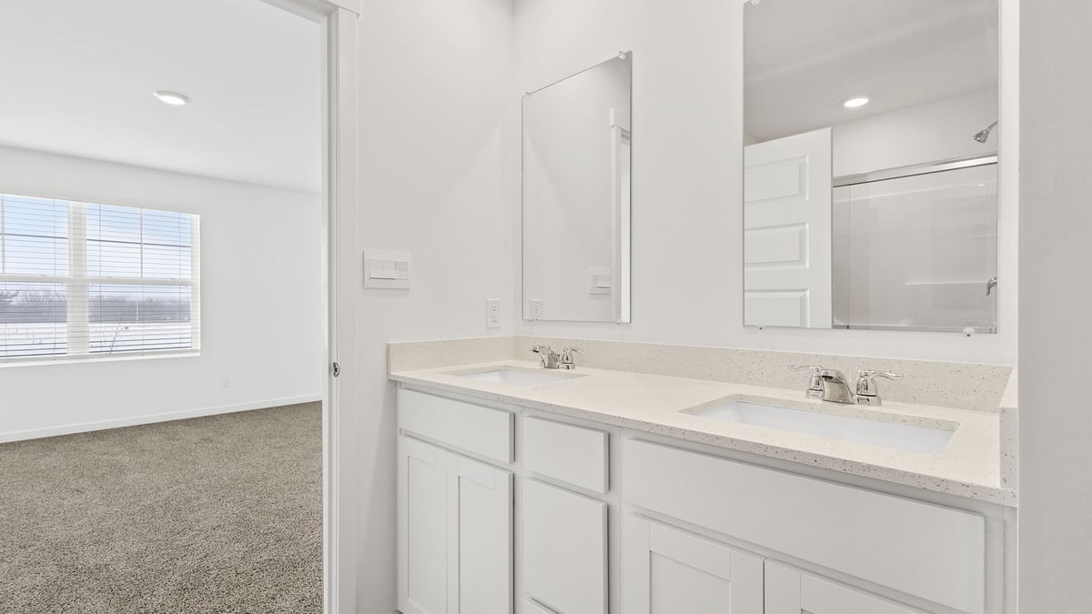 Primary bathroom with dual vanity sinks.