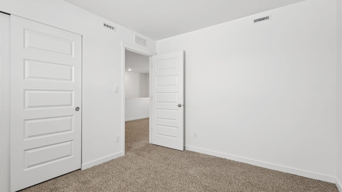 Bedroom with carpet and a closet.