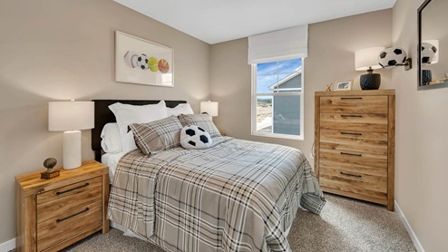 Bedroom with a single window and carpeted floors.