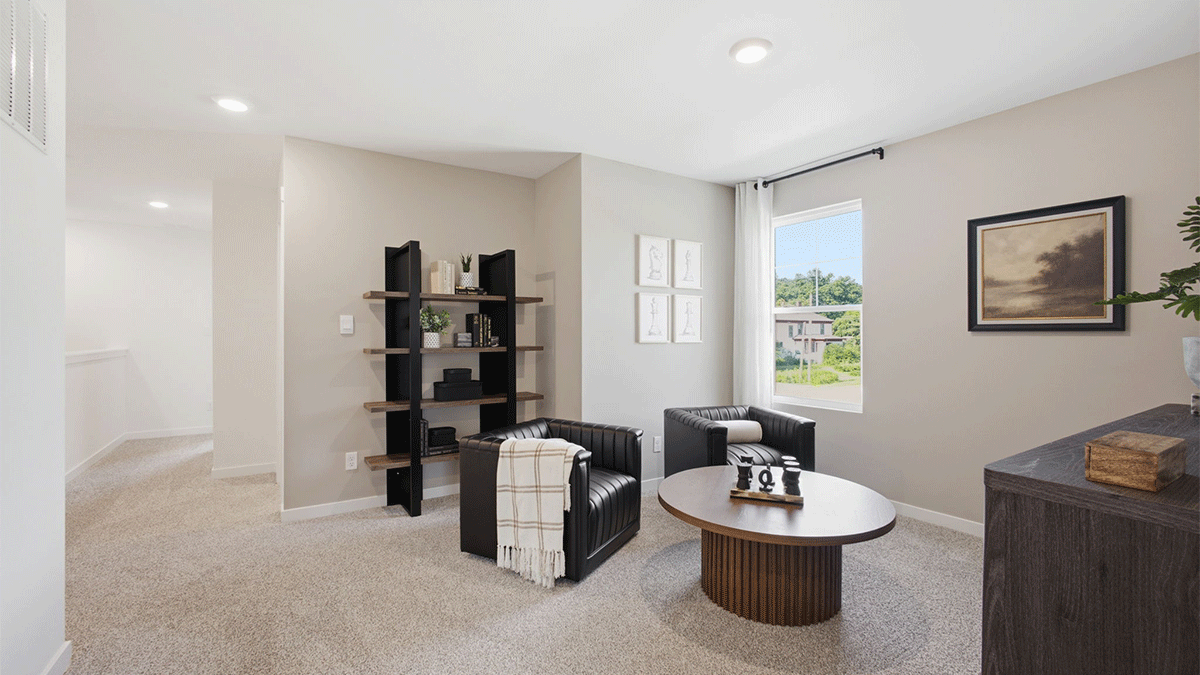 Loft area with carpeted floors and a one window.