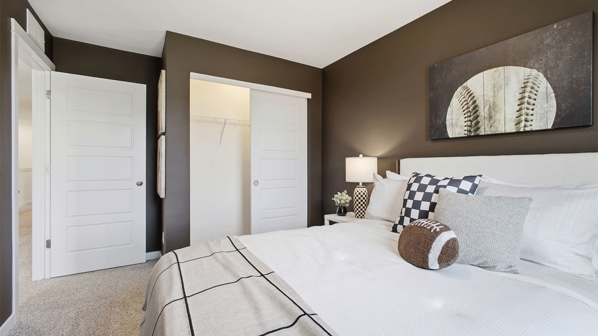 Bedroom with a closet and carpeted floors.