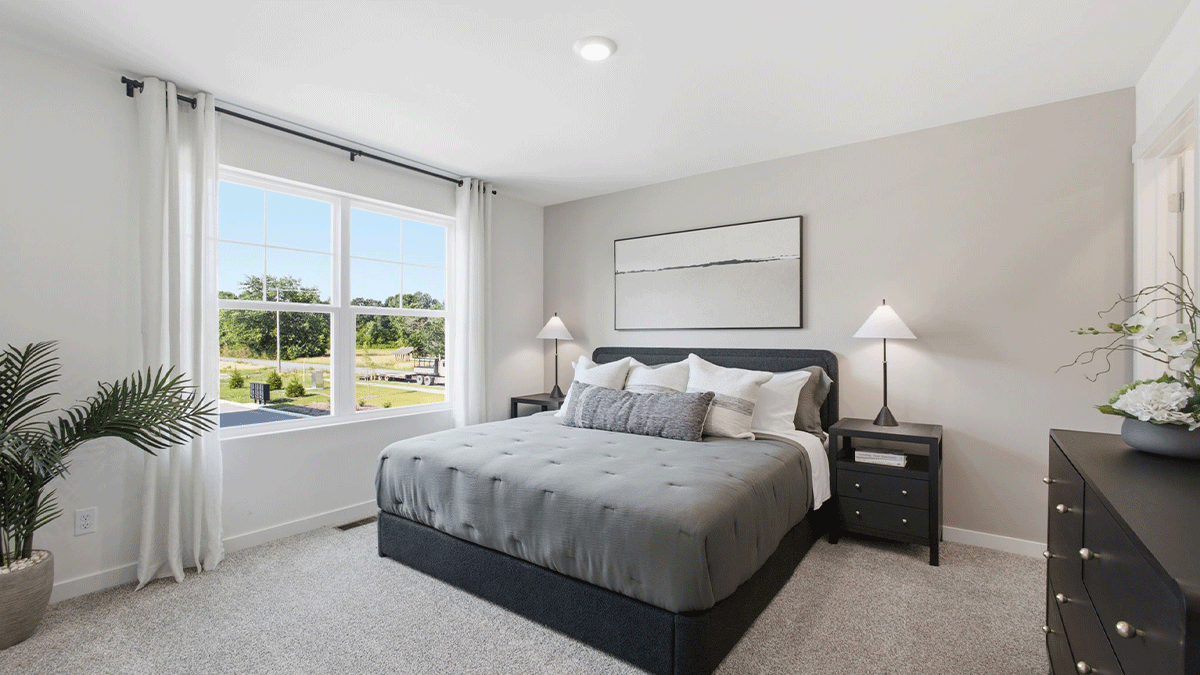Primary bedroom with plenty of space and a big window.