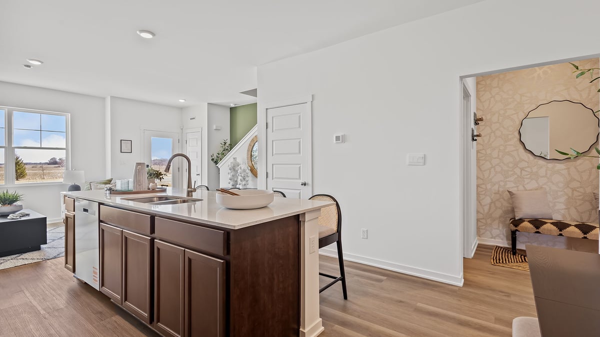 Kitchen island with quartz countertops and hard wood flooring.