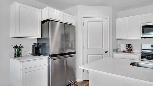 kitchen with white cabinetry, large island, and stainless steel appliances