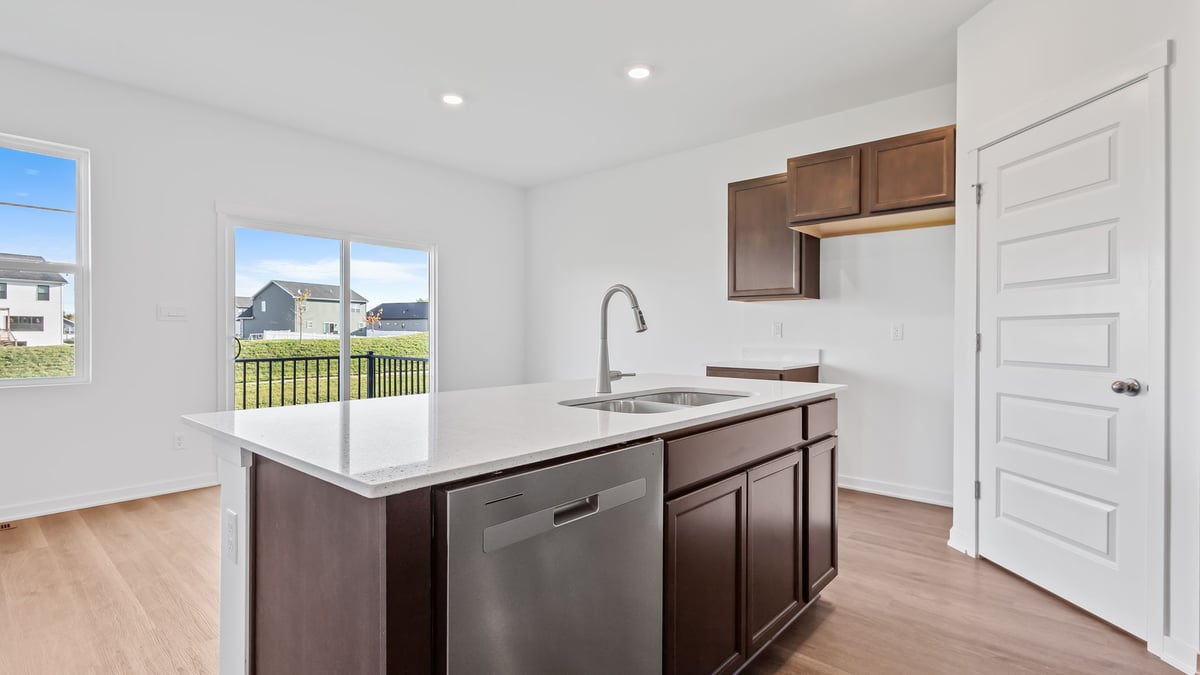 Kitchen island overlooking the dining area with a glass sliding door.