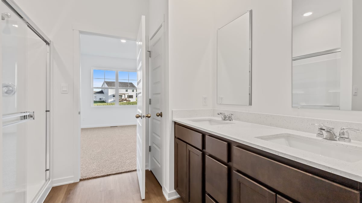 Dual vanity sink with a walk in shower.