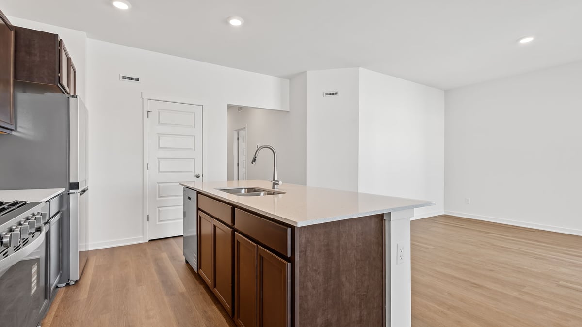 Kitchen island with hard wood floors and dining room.