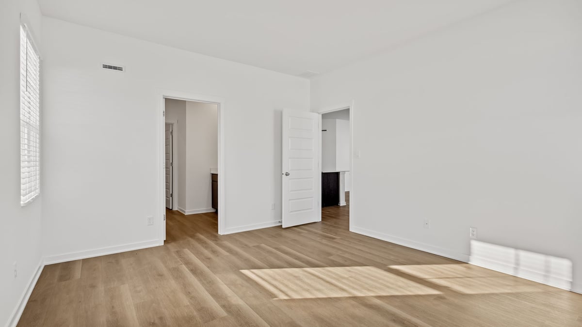 Hardwood floors with a bathroom.