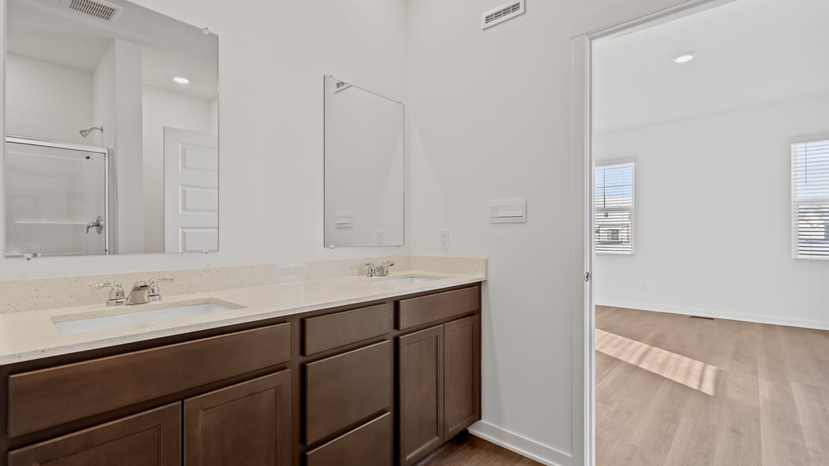 Dual vanity sink with a walk in shower.
