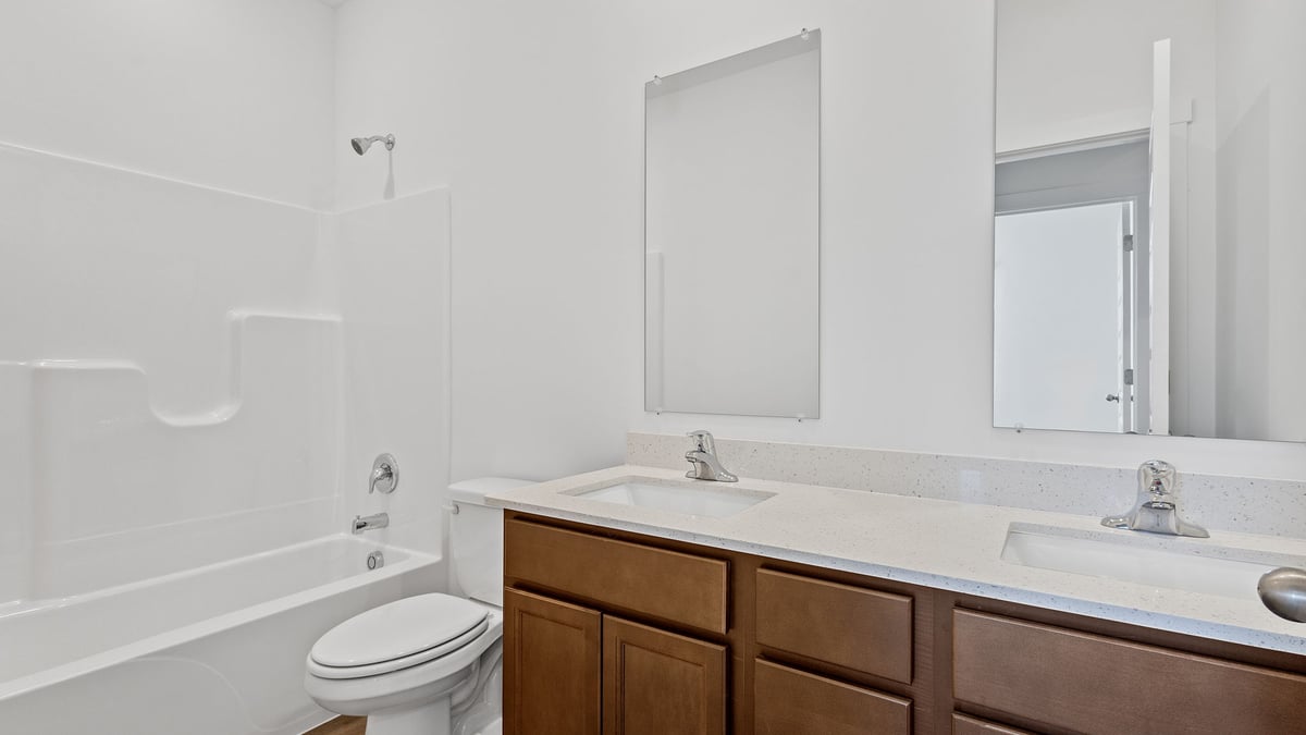 Bathroom with a shower and dual vanity sinks.