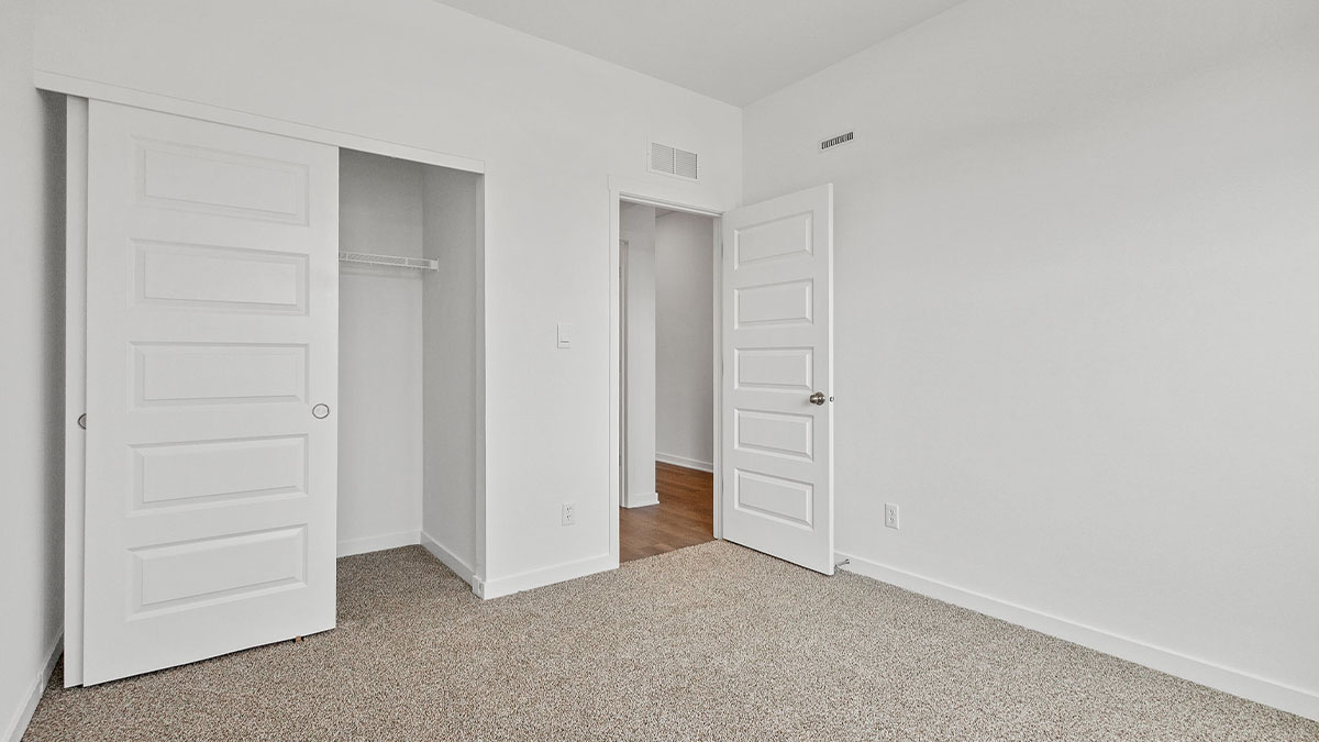 Bedroom with carpet and a closet.