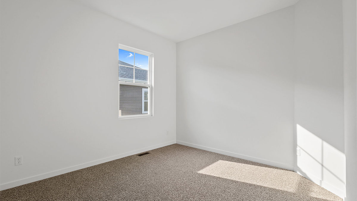 Bedroom with carpet and a window.