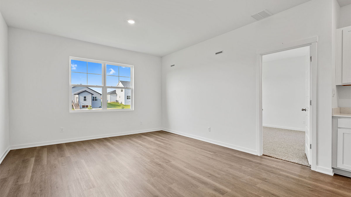 Room with hard wood floors with a window.