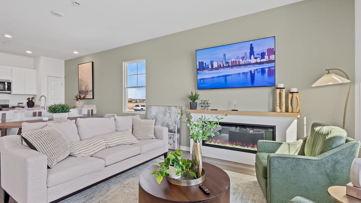 Living room area with a fireplace and a big window.