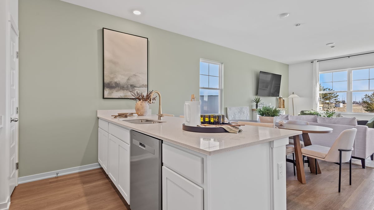 Kitchen area with a kitchen island and hard wood floors.