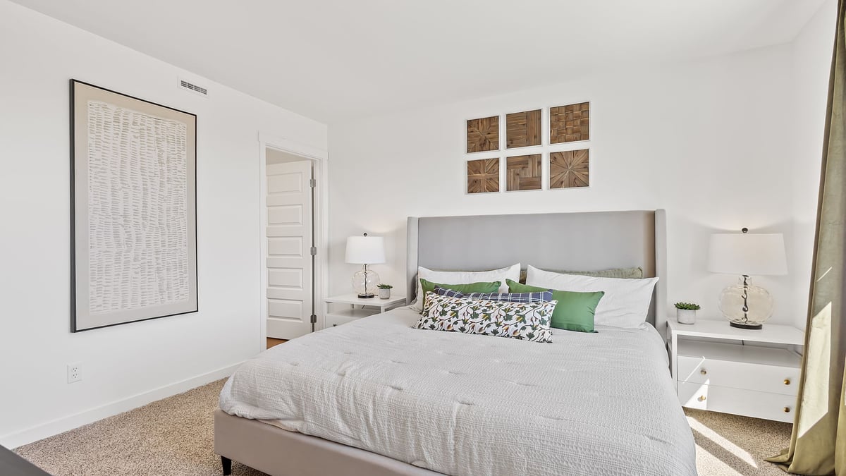 Primary bedroom with carpeted floors.