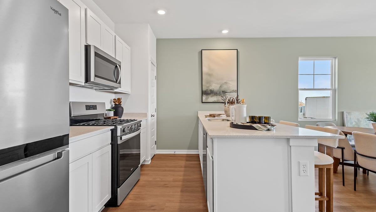 Kitchen with quartz countertops and white cabinets.