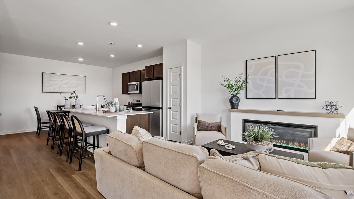 Living room with hard wood floors with a fireplace.