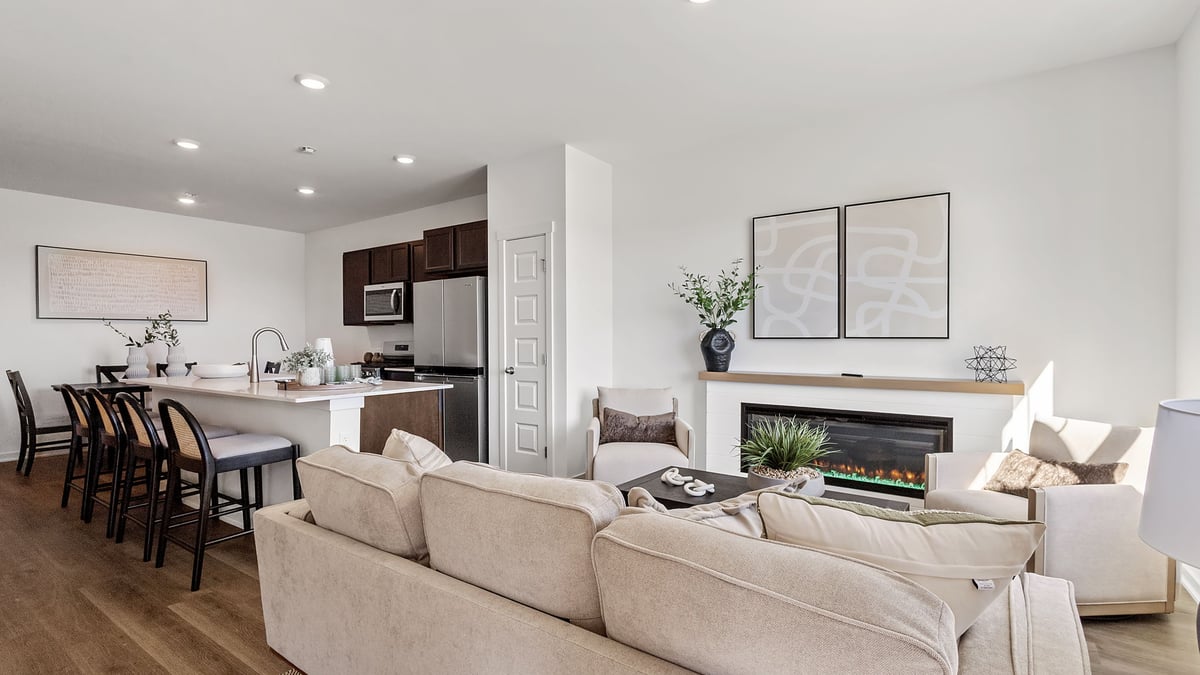 Open concept living room and kitchen with hard wood floors.
