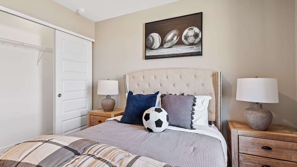 Bedroom staged as a kids sports room and a closet.