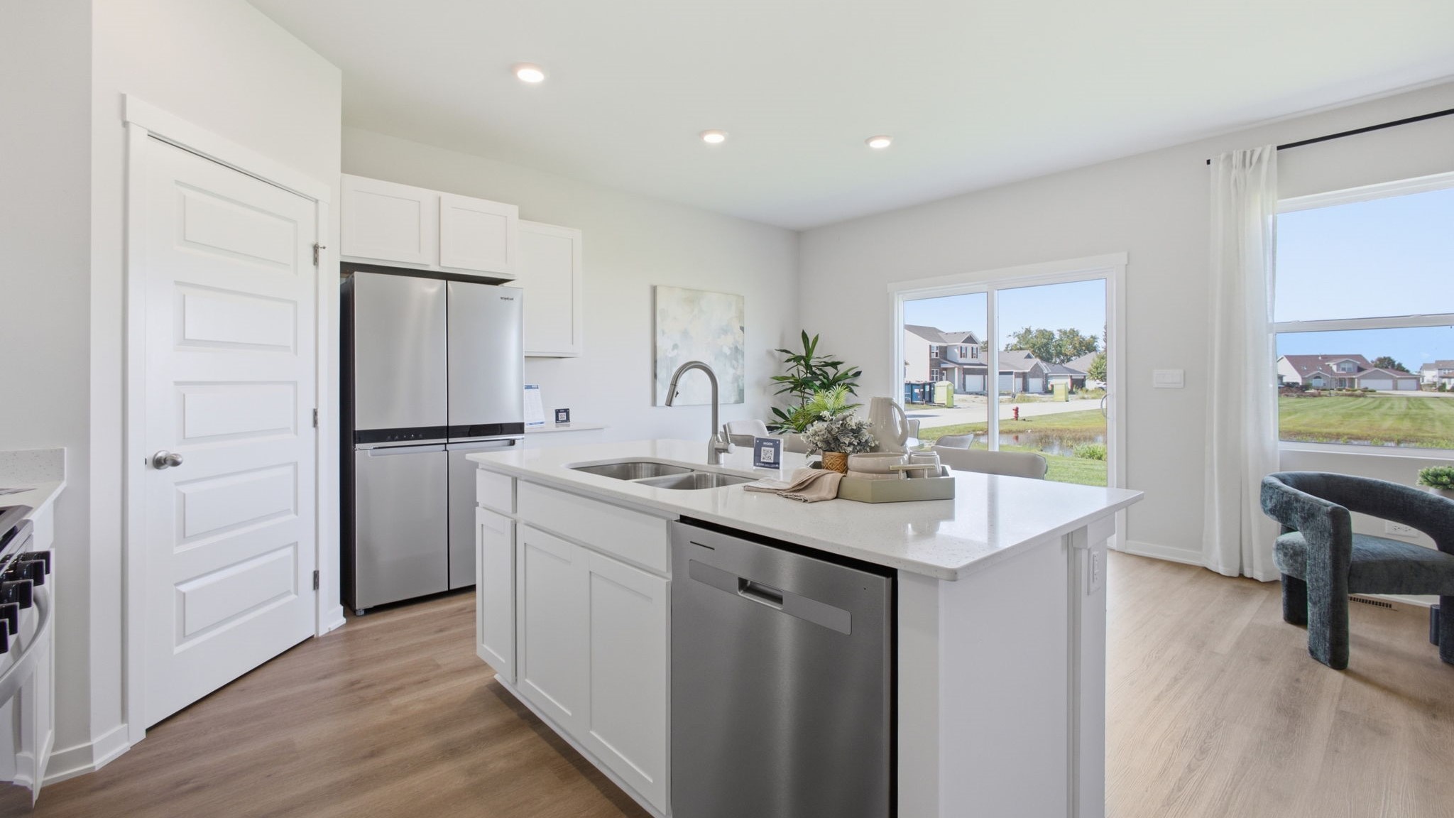 Kitchen with hardwood floors and stainless steel appliances.