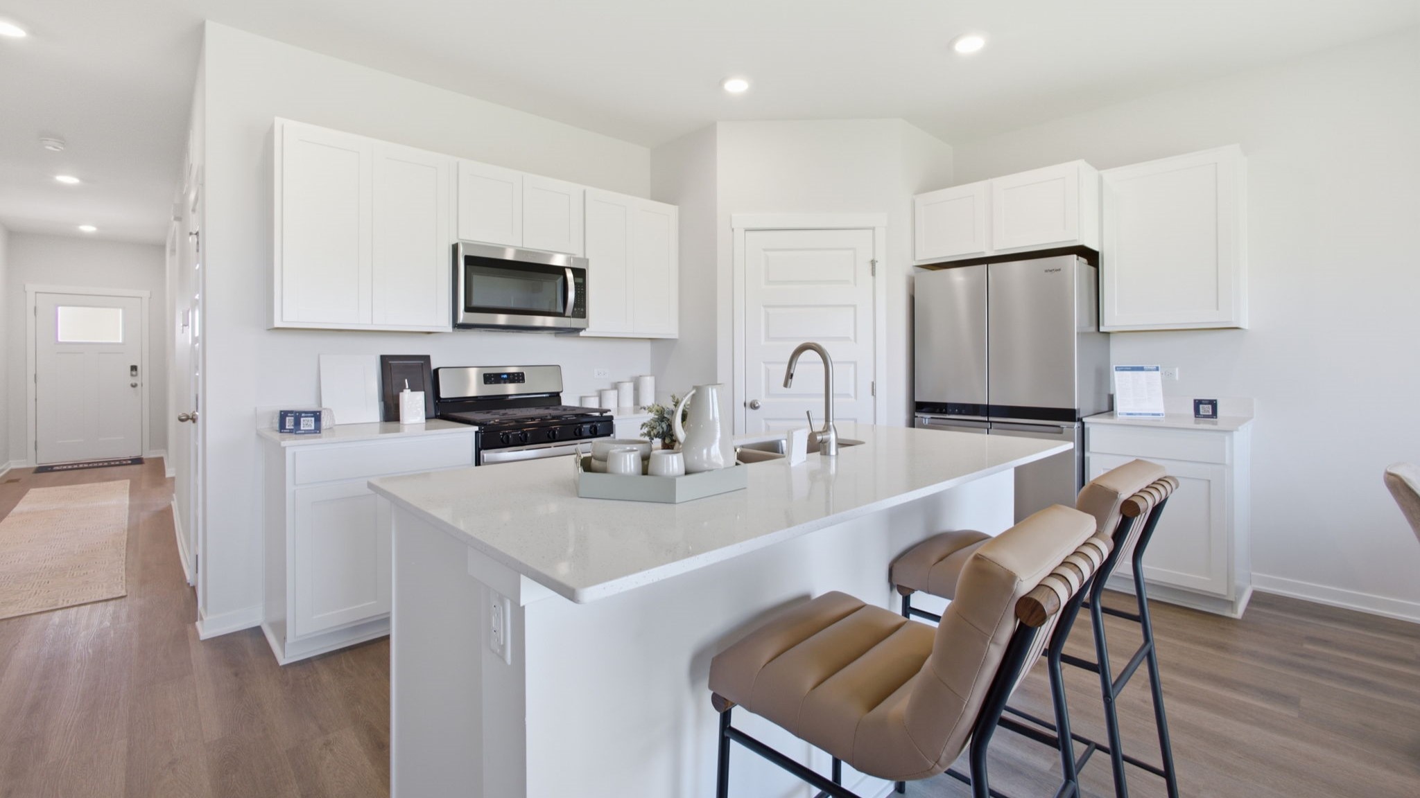 Kitchen area with white cabinetry.