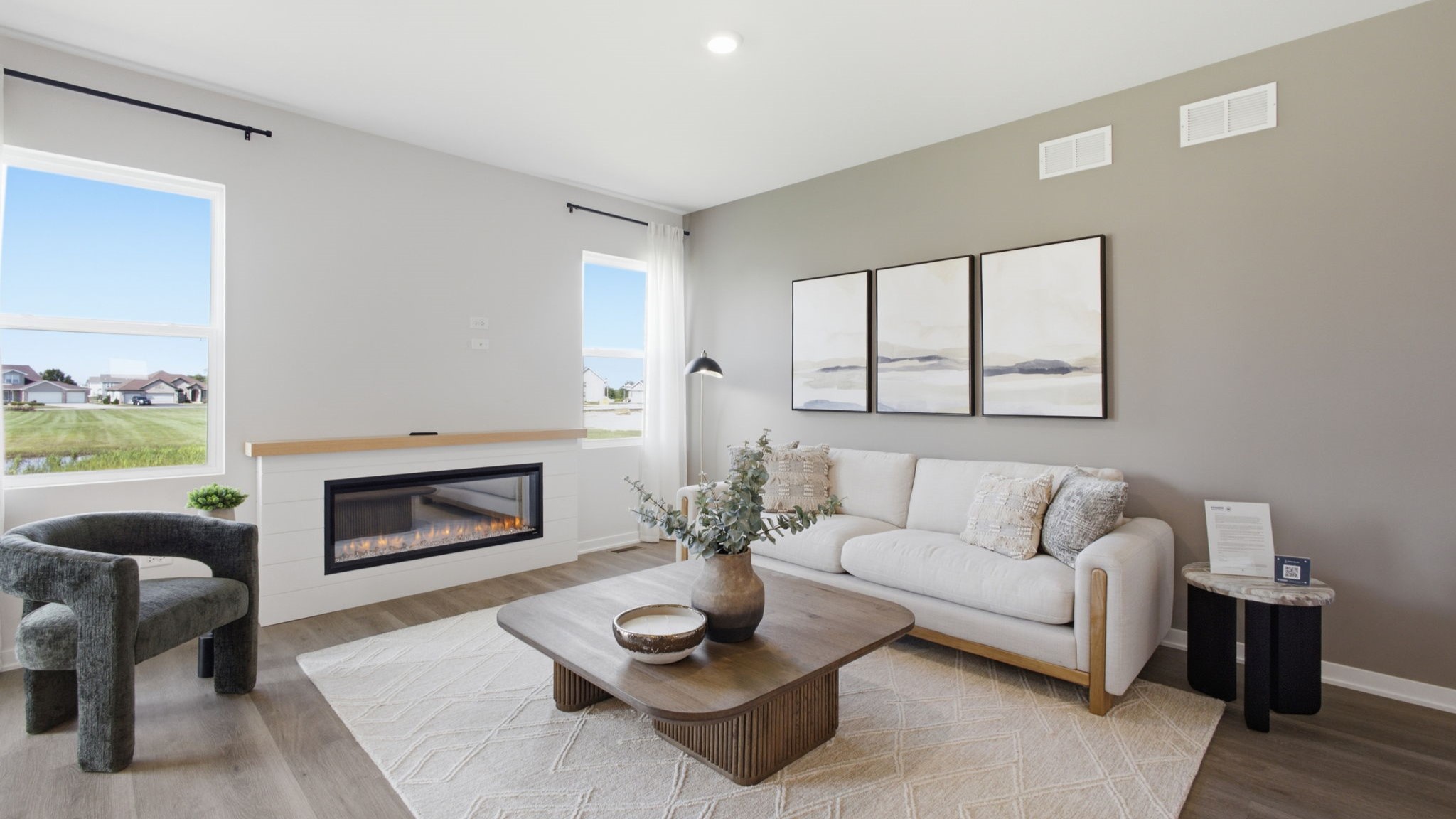 Spacious living area with large windows.