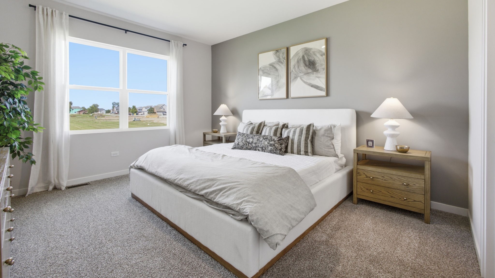 Primary bedroom with large windows.